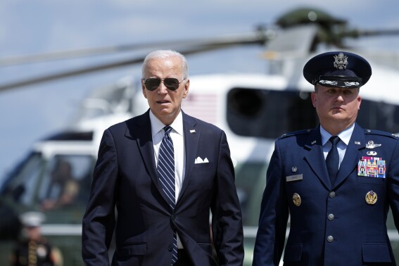 President Joe Biden, escorted by Col. Matthew E. Jones, Commander of the 89th Airlift Wing, walks to board Air Force One, Thursday, Aug. 17, 2023, at Andrews Air Force Base, Md. Biden is headed to Pennsylvania. (AP Photo/Alex Brandon)
