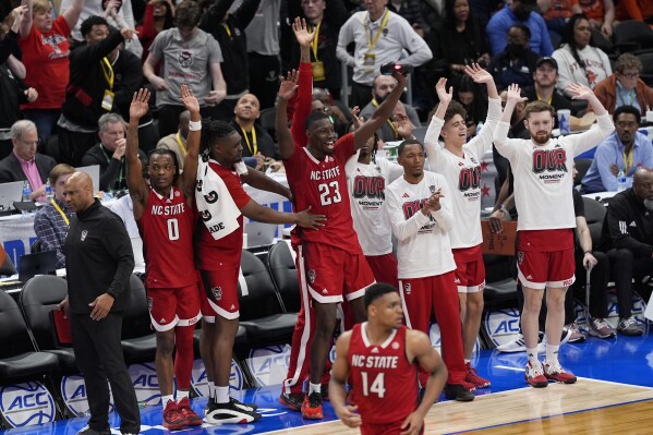 North Carolina State forward Mohamed Diarra (23) joins his teammates as they start to celebrate during the final minutes of the second half of the Atlantic Coast Conference NCAA college basketball tournament game against Syracuse, Wednesday, March 13, 2024, in Washington. (AP Photo/Susan Walsh)
