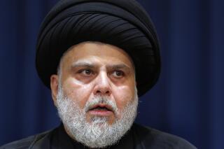FILE - Influential Shiite cleric Muqtada al-Sadr makes a speech from his house in Najaf, Iraq, Tuesday, Aug. 30, 2022. Influential Iraqi Shiite cleric and political leader al-Sadr announced Friday, April 14, 2023, that he would suspend the movement he leads for one year, citing “corruption” among some of his followers. (AP Photo/Anmar Khalil, File)
