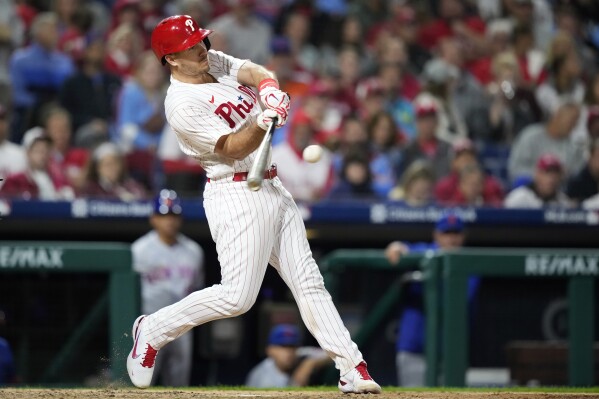 Philadelphia Phillies' J.T. Realmuto hits a three-run home run against New York Mets pitcher Tylor Megill during the sixth inning of a baseball game, Friday, Sept. 22, 2023, in Philadelphia. (AP Photo/Matt Slocum)