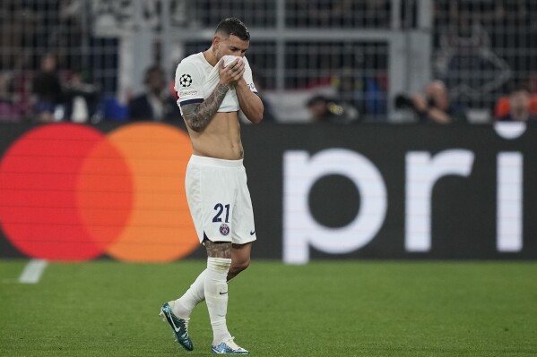 PSG's Lucas Hernandez leaves the pitch after being injured during the Champions League semifinal first leg soccer match between Borussia Dortmund and Paris Saint-Germain at the Signal-Iduna Park in Dortmund, Germany, Wednesday, May 1, 2024. (AP Photo/Martin Meissner)