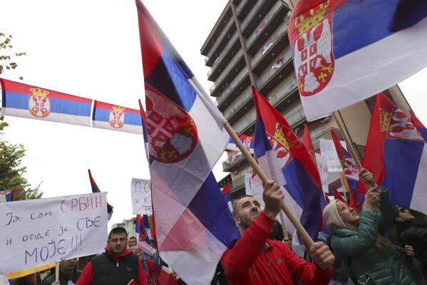 Kosovo Serbs wave Serbian flags during a protest in Mitrovica, Kosovo, Sunday, Nov. 6, 2022. Several thousand ethnic Serbs on Sunday rallied in Kosovo after a dispute over vehicle license plates triggered a Serb walkout from their jobs in Kosovo's institutions and heightened ongoing tensions stemming from a 1990s' conflict. (AP Photo/Bojan Slavkovic)
