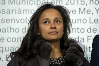 In this March 5, 2015 photo, Isabel dos Santos, reputedly Africa's richest woman, attends the opening of an art exhibition featuring works from the collection of her husband and art collector Sindika Dokolo in Porto, Portugal. On Monday, Jan. 6, 2020, Angola's foreign minister Manuel Augusto said that there is no political motivation behind the government's demand for more than $1 billion from dos Santos, her husband and a Portuguese business partner. Isabel dos Santos is a daughter of Jose Eduardo dos Santos, who ruled the oil- and diamond-rich nation for 38 years until 2017. (AP Photo/Paulo Duarte)