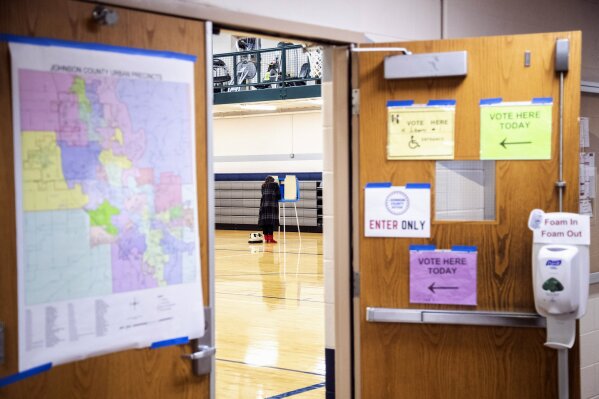 Signage directs voters to a polling location as people cast their ballot in the general election on Election Day, Tuesday, Nov. 3, 2020, at the North Liberty Community Center in North Liberty, Iowa. (Joseph Cress/Iowa City Press-Citizen via AP)