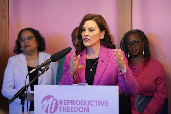 FILE - Michigan Gov. Gretchen Whitmer addresses supporters before signing legislation to repeal the 1931 abortion ban statute, which criminalized abortion in nearly all cases, during a bill signing ceremony, April 5, 2023, in Birmingham, Mich. Two key pieces of legislation that would have repealed a 24-hour wait period required for patients receiving an abortion and also allowed state Medicaid dollars to pay for abortions were left out of a package signed Tuesday, Nov. 21, 2023, by Whitmer. (AP Photo/Carlos Osorio, File)
