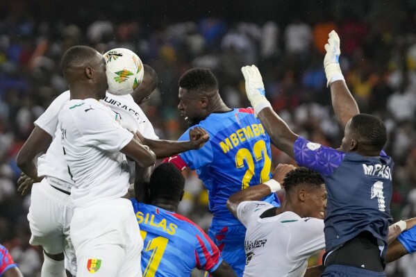 Guinea's Mouctar Diakhaby, left, heads the ball during the African Cup of Nations quarter final soccer match between DR Congo and Guinea, at the Olympic Stadium of Ebimpe in Abidjan, Ivory Coast, Friday, Feb. 2, 2024. (APPhoto/Themba Hadebe)
