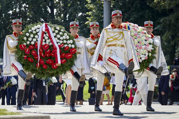 Honor guards carry wreaths during an event held to celebrate Moldova's national day, three decades after the country declared independence from the Soviet Union, in Chisinau, Moldova, Friday, Aug. 27, 2021. The 30-year anniversary event was held in the capital's Grand National Assembly Square where President Maia Sandu was joined by Poland's President Andrzej Duda, Ukraine's President Volodymyr Zelenskyy and Romania's President Klaus Iohannis (AP Photo/Aurel Obreja)