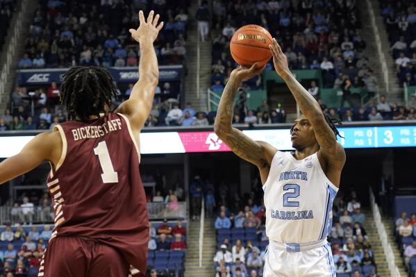 North Carolina guard Caleb Love (2) shoots over Boston College forward T.J. Bickerstaff (1) during the first half of an NCAA college basketball game at the Atlantic Coast Conference Tournament in Greensboro, N.C., Wednesday, March 8, 2023. (AP Photo/Chuck Burton)