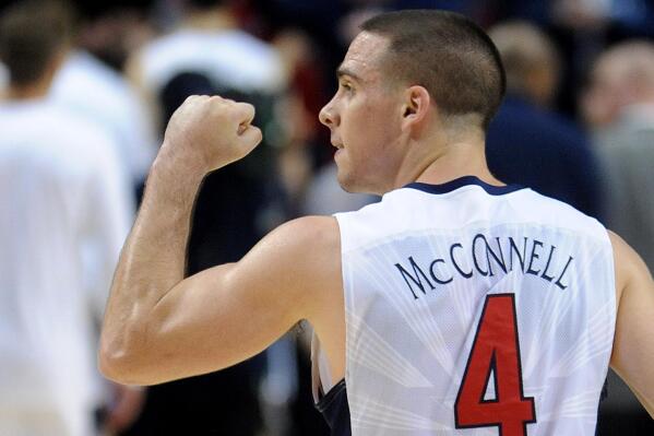 Arizona guard T.J. McConnell pumps his fist to the crowd after winning an NCAA college basketball tournament round of 32 game against Ohio State in Portland, Ore., Saturday, March 21, 2015. McConnell led Arizona in scoring with 19 points as they won 73-58. (AP Photo/Greg Wahl-Stephens)