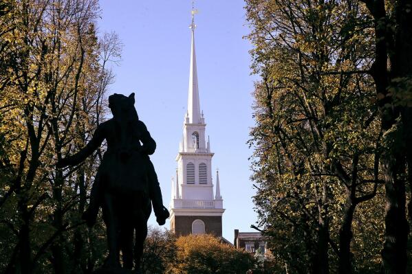 FILE— In this Nov. 7, 2018 file photograph, the Old North Church stands behind a statue of Paul Revere in the North End neighborhood of Boston. The church is famous as the place where in 1775 two lanterns in the steeple signaled that the British were heading to Concord and Lexington, but it's not well known that some of the church's early congregants were slave holders. Now the church, with a grant from the National Endowment for the Humanities, is integrating that history into its educational mission. (AP Photo/Steven Senne, File)