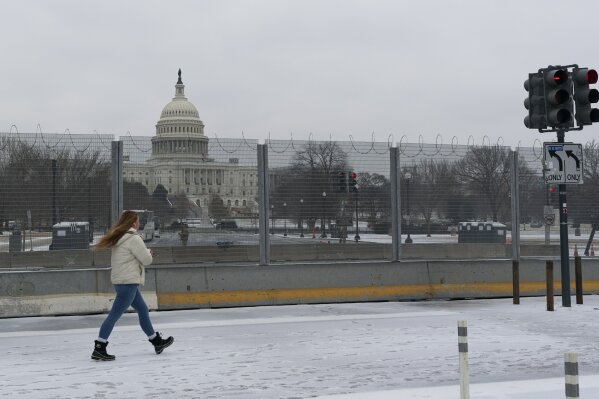 The U.S. Capitol is seen behind the metal security fencing around the U.S. Capitol, Thursday, Feb. 18, 2021. U.S. Capitol Police officials told congressional leaders the razor-wire topped fencing around the Capitol should remain in place for several more months as law enforcement continues to track threats against lawmakers, a person familiar with the matter told The Associated Press on Thursday. (AP Photo/Manuel Balce Ceneta)