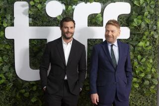 Director Kenneth Branagh, right, and actor Jamie Dornan walk the red carpet as they promote the film "Belfast" during the Toronto International Film Festival, in Toronto, Sunday, Sept. 12, 2021. (Chris Young/The Canadian Press via AP)