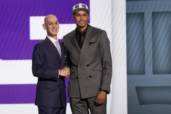 Keegan Murray, right, poses for photos with NBA Commissioner Adam Silver after being selected fourth overall by the Sacramento Kings in the NBA basketball draft, Thursday, June 23, 2022, in New York. (AP Photo/John Minchillo)