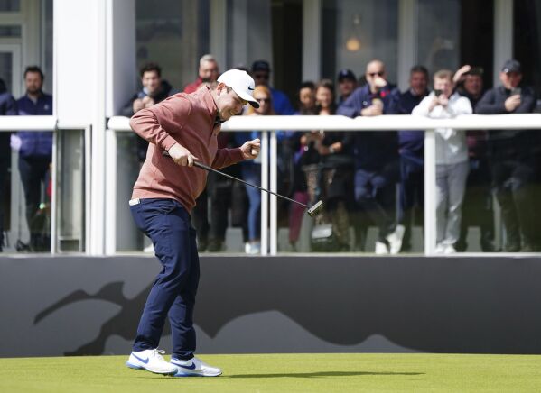 Robert MacIntyre celebrates on the 18th green on day four of the Genesis Scottish Open 2023 golf tournament at The Renaissance Club, North Berwick, Britain, Sunday, July 16, 2023. (Jane Barlow/PA via AP)