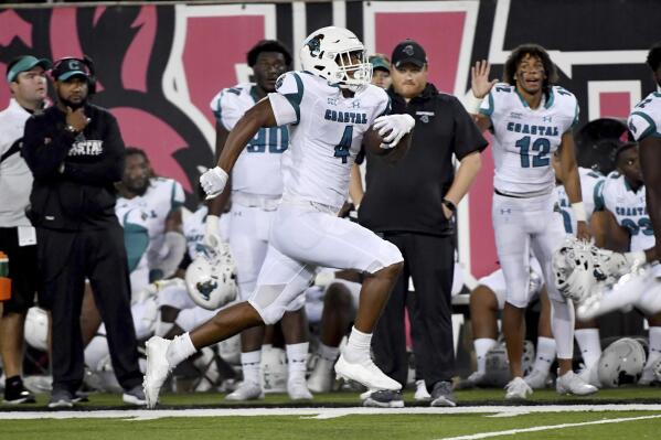 FILE - Coastal Carolina tight end Isaiah Likely (4) runs for a touchdown against Arkansas State during the second half of an NCAA college football game  in Jonesboro, Ark., in this Thursday, Oct. 7, 2021, file photo. Likely was selected to The Associated Press Midseason All-America team, announced Tuesday, Oct. 19, 2021. (AP Photo/Michael Woods, File)