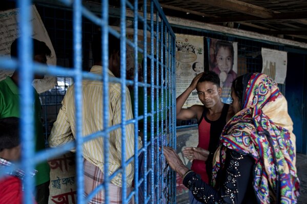 
              In this Oct. 1, 2017, photo Rohingya man Alam Jafar, second right, stands with other Rohingya refugees at a transit shelter at Kutupalong camp for newly arrived Rohingya refugees in Bangladesh. In Myanmar, the 25-year-old farmer owned a verdant rice field, a boat that ferried passengers up and down the river and lived in a four-room house made of wood and bamboo surrounded by coconut and mango trees. When the mob came to his village on Sept. 25, Jafar had no choice but to flee with his wife and three children. On Sept. 28, the small fishing boat they were traveling in capsized while it was bound for Bangladesh and left him as the sole survivor of the family of 5. (AP Photo/Gemunu Amarasinghe)
            
