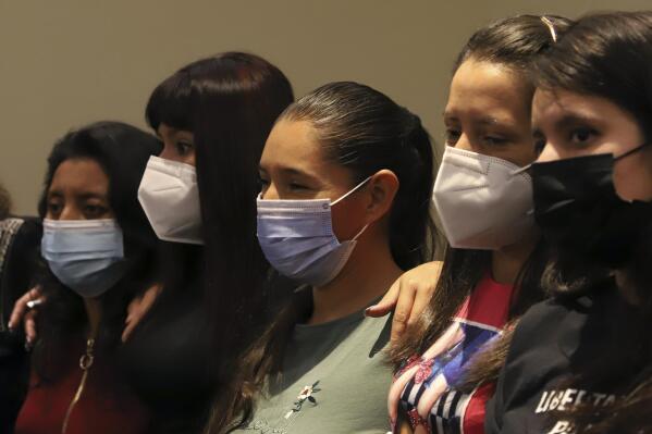 From left, Elsy, Kenia, Evelyn and Karen pose for a photo with Sara Garcia of the Citizen’s Group for the Depenalization of Abortion, far right, during the press conference in San Salvador, El Salvador, Tuesday, Feb. 22, 2022. Elsy, Kenia, Evelyn and Karen are four of five women who were were released since Christmas after having served long stretches of 30-year prison sentences for allegedly terminating their pregnancies, in a country that bans abortion under any circumstances. (AP Photo/Salvador Melendez)