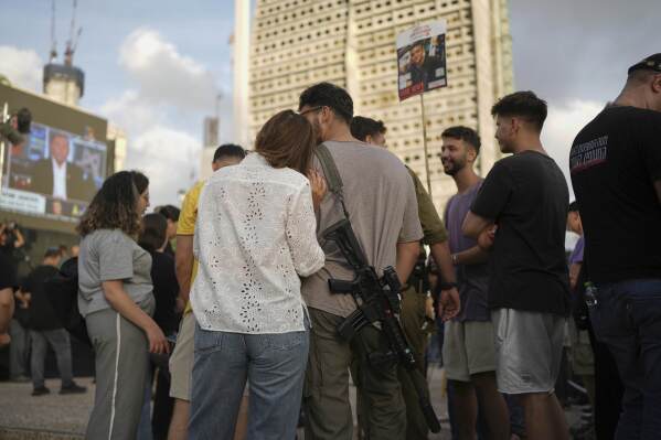 People gather to watch a live broadcast of Israeli-American soldier Edan Alexander as he is released from Hamas captivity in Gaza, at a plaza known as the hostages square in Tel Aviv, Monday, May 12, 2025. Alexander was abducted during the Hamas-led attack on his base on October 7, 2023. (AP Photo/Oded Balilty)