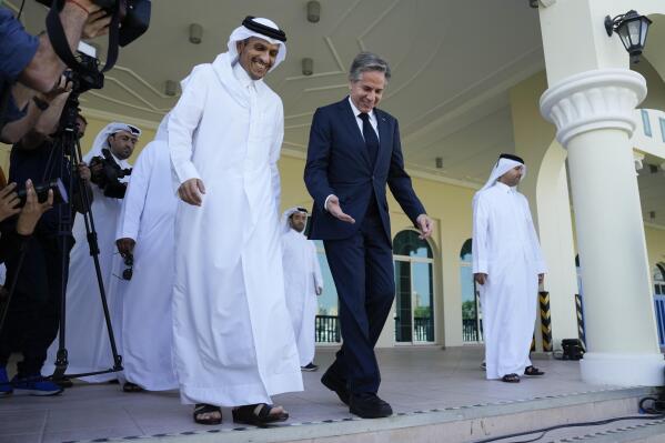 United States Secretary of State Antony Blinken, right, and Qatar Foreign Minister Mohammed Bin Adbulrahman Al Thani, left, walk to a media event at the Diplomatic Club, in Tuesday, Nov. 22, 2022. America's top diplomat criticized a decision by FIFA to threaten players at the World Cup with yellow cards if they wear armbands supporting inclusion and diversity. (AP Photo/Ashley Landis)