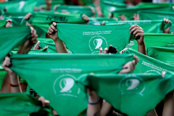 
              FILE - In this April 10, 2018, file photo, abortion-rights demonstrators raise green handkerchiefs during a rally in front of the National Congress in Buenos Aires, Argentina. The homeland of Pope Francis was closer than ever this year to legalizing abortion after a wave of demonstrations by women’s rights groups and shifting public opinion. The demonstrators staged wide protests in the streets of Argentina wearing green handkerchiefs that symbolize the abortion rights movement. (AP Photo/Natacha Pisarenko, File)
            