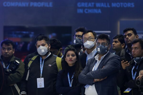 Delegates wear face mask as they attend an event at the Auto Expo in Greater Noida, near New Delhi, India, Wednesday, Feb. 5, 2020. Indian organizers said they were unhappy over the cancellation of more than 296 Chinese delegates and exhibitors who skipped India’s biggest auto show due to the outbreak. Visitors at the event were greeted by signs warning against the disease, and many wore masks as they strolled around the exhibition in New Delhi. (AP Photo/Altaf Qadri)
