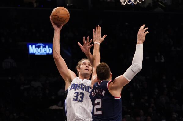 Orlando Magic center Robin Lopez (33) goes to the basket against Brooklyn Nets forward Blake Griffin (2) during the first half of an NBA basketball game, Saturday, Dec. 18, 2021, in New York. (AP Photo/Mary Altaffer)