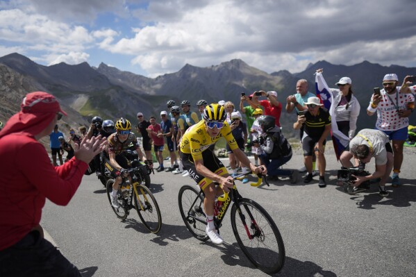 FILE - Stage winner and new overall leader Denmark's Jonas Vingegaard, left, and Slovenia's Tadej Pogacar, wearing the overall leader's yellow jersey, climb during the eleventh stage of the Tour de France cycling race over 152 kilometers (94.4 miles) with start in Albertville and finish in Col du Granon Serre Chevalier, France, Wednesday, July 13, 2022. The 110th edition of the Tour de France starting Saturday, July 1, 2023 from Bilbao, Spain, will feature a mouthwatering duel between defending champion Jonas Vingegaard and two-time winner Tadej Pogacar. (AP Photo/Thibault Camus, File)