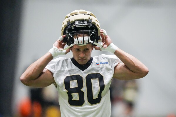 New Orleans Saints tight end Jimmy Graham (80) dons his helmet at the NFL team's football training camp in Metairie, La., Friday, Aug. 4, 2023. (AP Photo/Gerald Herbert)