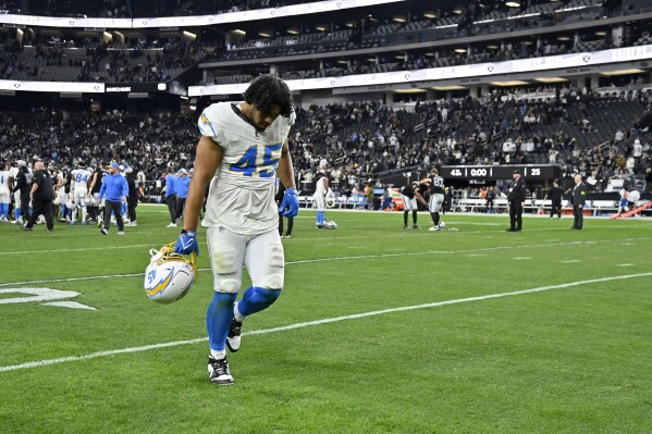 Los Angeles Chargers linebacker Tuli Tuipulotu (45) walks off the field after a loss to the Las Vegas Raiders in an NFL football game, Thursday, Dec. 14, 2023, in Las Vegas. (AP Photo/David Becker)