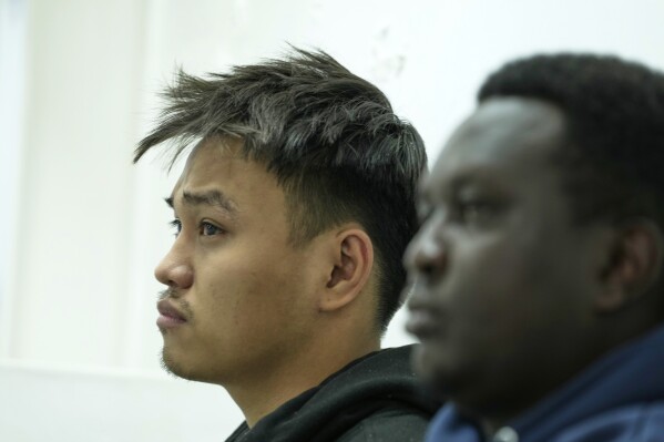 Vietnamese national Duh Hung Nguyen, left, and Kenyan national Dennis Ng'ang'a who are charged to the illegal possession and trafficking of live queen ants to sell as exotic pets, appear at the Jomo Kenyatta International Airport Law Courts in Nairobi, Kenya Tuesday, April. 15, 2025. (AP Photo/Brian Inganga)