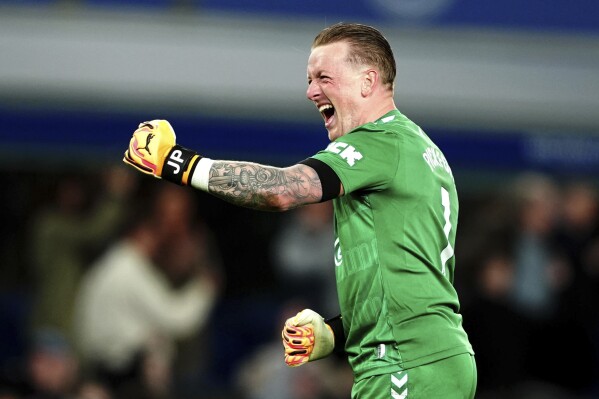 Everton goalkeeper Jordan Pickford celebrates following the English Premier League soccer match between Everton and Liverpool at the Goodison Park stadium in Liverpool, Britain, Wednesday, April 24, 2024. (Peter Byrne/PA via AP)
