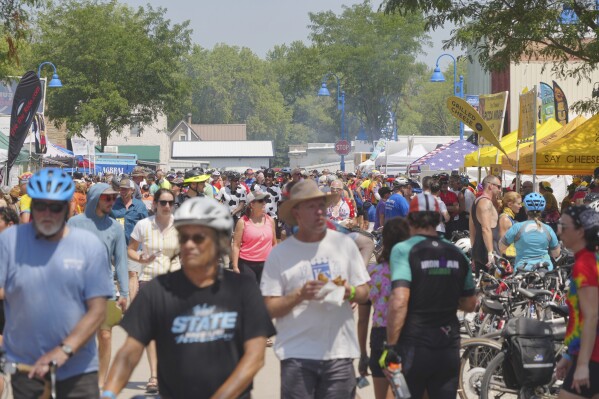 Riders participating in RAGBRAI - the Register’s Annual Great Bicycle Ride Across Iowa- arrive in Lake View, Iowa, as they move towards Carroll, Iowa, Monday, July 24, 2023. (Zach Boyden-Holmes/The Des Moines Register via AP)