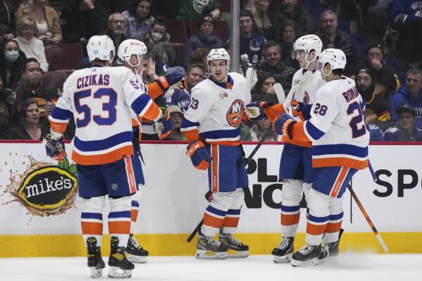 New York Islanders' Mathew Barzal, center, celebrates his goal against the Vancouver Canucks with Casey Cizikas, Josh Bailey, Noah Dobson and Alexander Romanov, from left, during the second period of an NHL hockey game Tuesday, Jan. 3, 2023, in Vancouver, British Columbia. (Darryl Dyck/The Canadian Press via AP)