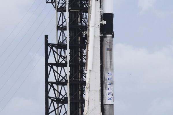 SpaceX Falcon 9 rocket with the Crew Dragon capsule stands ready for launch on pad 39A for a mission to the International Space Station at the Kennedy Space Center in Cape Canaveral, Fla., Wednesday, June 11, 2025. (AP Photo/Terry Renna)
