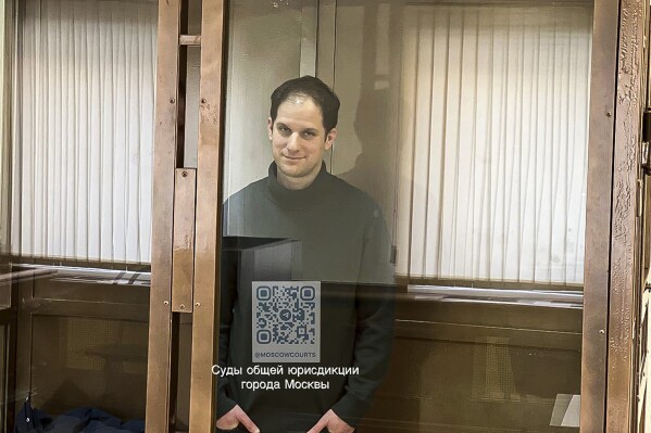 In this photo released by the Moscow's City Court, Wall Street Journal reporter Evan Gershkovich stands in a glass cage in a courtroom at the Moscow City Court, in Moscow, Russia, on Tuesday, Feb. 20, 2024. (Moscow City Court via AP)