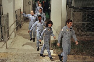 FILE - In this Jan. 27, 1986, file photo, the crew for the Space Shuttle Challenger flight 51-L leaves their quarters for the launch pad at the Kennedy Space Center in Florida. (AP Photo/Steve Helber, File)