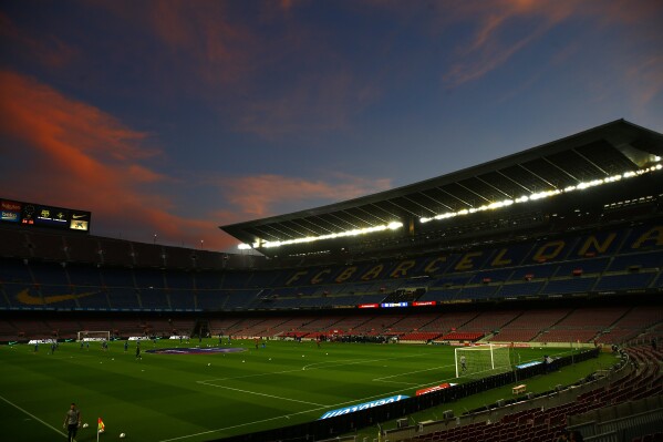 FILE - In this April 5, 2021 file photo, a general view of the the Camp Nou stadium as the sun sets ahead of the Spanish La Liga soccer match between FC Barcelona and Valladolid CF in Barcelona, Spain. Beyond being able to court and train up some of the world’s top soccer talent, Barcelona has also based its success on a strong home advantage thanks to Europe’s largest soccer stadium. That will be different this season, when the team plays at a smaller, less accessible stadium while its 99,000-seat Camp Nou undergoes a complete facelift. (AP Photo/Joan Monfort, File)