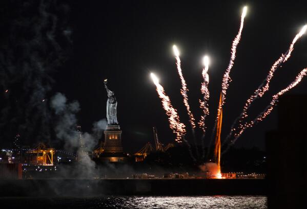 Fireworks launched from a barge explode over New York Harbor and the Statue of Liberty as New York and other cities around New York state recognize a rate of 70% for single dose vaccinations against the COVID-19 virus, Tuesday, June 15, 2021 in New York. Celebration of the milestone was announced by Gov. Andrew Cuomo earlier in the day. (AP Photo/Craig Ruttle)