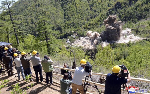 
              In this Thursday, May 24, 2018 photo provided by the North Korean government, foreign media on a viewing platform watch and record as North Korea’s nuclear test site is blown up at Punggye-ri, North Hamgyong Province, North Korea. The content of this image is as provided and cannot be independently verified. Korean language watermark on image as provided by source reads: "KCNA" which is the abbreviation for Korean Central News Agency. (Korean Central News Agency/Korea News Service via AP)
            