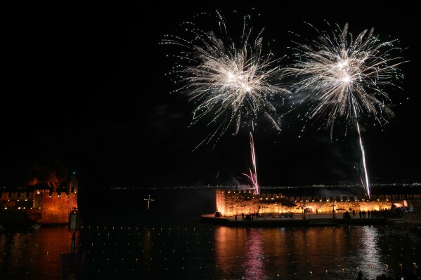 Fireworks explode over the Venetian port after the procession of "Epitaphios", the bier that carries the body of Jesus Christ to his grave, in Nafpaktos town, western Greece, on Good Friday, May 3, 2024. The solemn processions in Greece, with the flower-adorned biers followed by the clergy and the faithful, are often spectacular, especially in places where bier processions from each parish converge into a central square. (Ǻ Photo/Thanassis Stavrakis)