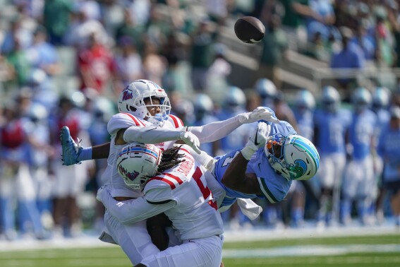 Tulane wide receiver Jha'Quan Jackson is hit as he tries to catch a pass by Mississippi safety John Saunders Jr. (5) and safety Daijahn Anthony in the first half of an NCAA college football game in New Orleans, Saturday, Sept. 9, 2023. (AP Photo/Gerald Herbert)