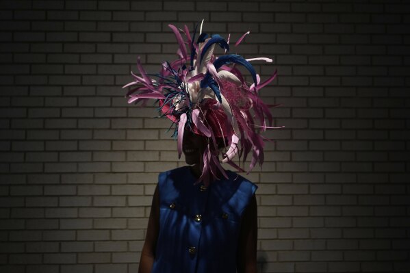 Hailey Burton stands in a hallway at Churchill Downs before the 151st running of the Kentucky Oaks horse race Friday, May 2, 2025, in Louisville, Ky. (AP Photo/Brynn Anderson)