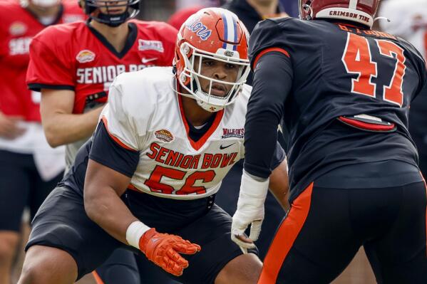 American lineman O'Cyrus Torrence of Florida (56) blocks out during practice for the Senior Bowl NCAA college football game Wednesday, Feb. 1, 2023, in Mobile, Ala.. (AP Photo/Butch Dill)