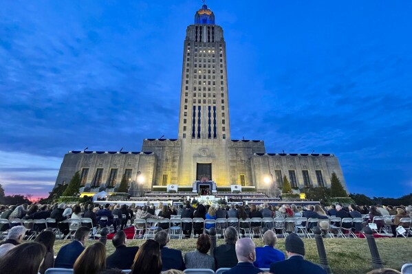 People listen to Louisiana Republican Gov. Jeff Landry speak during his inauguration ceremony at the State Capitol building in Baton Rouge, La., Sunday, Jan. 7, 2024. The inauguration, originally scheduled for Monday, was pushed up a day early due to weather concerns. (AP Photo/Matthew Hinton)