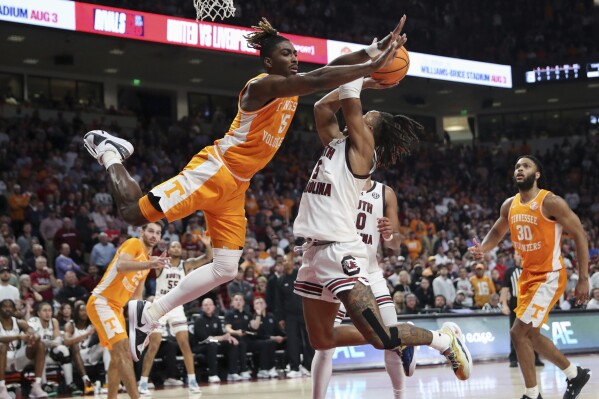 South Carolina guard Meechie Johnson (5) is fouled by Tennessee guard Jahmai Mashack (15) during the second half of an NCAA college basketball game Wednesday, March 6, 2024, in Columbia, S.C. (AP Photo/Artie Walker Jr.)