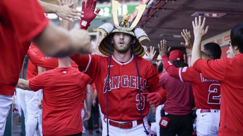 Los Angeles Angels' Taylor Ward celebrates in the dugout after hitting a home run during the first inning of a baseball game against the New York Yankees in Anaheim, Calif., Wednesday, July 19, 2023. Los Angeles Angels designated hitter Shohei Ohtani also scored. (AP Photo/Ashley Landis)