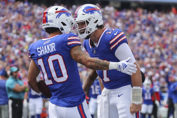 Buffalo Bills quarterback Josh Allen, right, celebrates with wide receiver Khalil Shakir (10) after they connected for a touchdown during the first half of an NFL football game against the Las Vegas Raiders, Sunday, Sept. 17, 2023, in Orchard Park, N.Y. (AP Photo/Jeffrey T. Barnes)