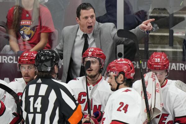 Carolina Hurricanes head coach Rod Brind'Amour, center rear, argues a call with referee Trevor Hanson (14) during the third period of Game 3 of the NHL hockey Stanley Cup Eastern Conference finals against the Florida Panthers, Monday, May 22, 2023, in Sunrise, Fla. (AP Photo/Wilfredo Lee)