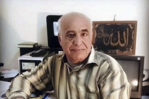 This photo provided by the family of Saleh Sariyeh, a Palestinian originally from the Ein el-Hilweh refugee camp in Lebanon, and who had lived in Derna for decades, shows him posing for a photograph in the Libyan city of Derna in 2023. On Monday, the 62-year-old architect was killed along with his wife and two daughters in Libya’s coastal city of Derna, when their home was washed away by flooding that devastated the city. (Courtesy of family of Saleh Sariyeh via AP)