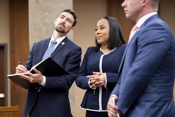 Fulton County District Attorney Fani Willis, center, and members of her team watch as potential jurors are excused during proceedings to seat a special purpose grand jury in Fulton County, Georgia, on Monday, May 2, 2022, to look into the actions of former President Donald Trump and his supporters who tried to overturn the results of the 2020 election. The hearing took place in Atlanta. (AP Photo/Ben Gray)